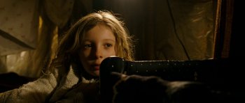 Movie still from “Deadfall” (2012), directed by Stefan Ruzowitzky – A young girl is sitting in a chair; Close Up shot, Low angle
