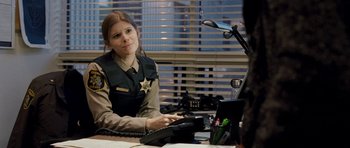 Movie still from “Deadfall” (2012), directed by Stefan Ruzowitzky – A woman sitting at a desk in front of a computer; Medium shot, Over the shoulder angle