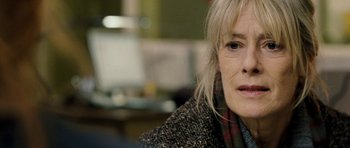 Movie still from “Deadfall” (2012), directed by Stefan Ruzowitzky – An older woman is looking into the distance; Close Up shot, Over the shoulder angle