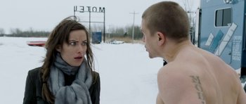 Movie still from “Deadfall” (2012), directed by Stefan Ruzowitzky – A woman and a man standing next to each other in the snow; Close Up shot, Over the shoulder angle