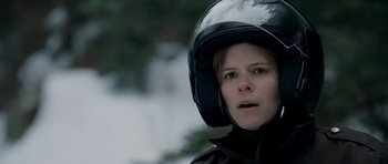 Movie still from “Deadfall” (2012), directed by Stefan Ruzowitzky – A woman wearing a motorcycle helmet and a black jacket; Close Up shot, Over the shoulder angle
