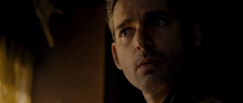 Movie still from “Deadfall” (2012), directed by Stefan Ruzowitzky – A man's face in a dark room; Close Up shot, Low angle
