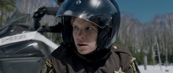 Movie still from “Deadfall” (2012), directed by Stefan Ruzowitzky – A woman in a police uniform wearing a helmet; Close Up shot, Over the shoulder angle