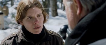 Movie still from “Deadfall” (2012), directed by Stefan Ruzowitzky – A woman in a black jacket talking to a man in a black jacket; Close Up shot, Over the shoulder angle