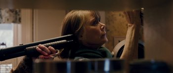 Movie still from “Deadfall” (2012), directed by Stefan Ruzowitzky – A woman blow drying her hair with a blow dryer; Close Up shot, Over the shoulder angle