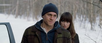 Movie still from “Deadfall” (2012), directed by Stefan Ruzowitzky – A man and a woman standing next to each other in the snow; Close Up shot, Over the shoulder angle