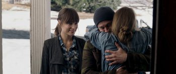 Movie still from “Deadfall” (2012), directed by Stefan Ruzowitzky – A group of young people hugging each other outside; Medium shot, Over the shoulder angle