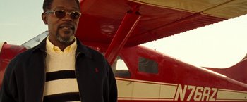 Movie still from “Deep Blue Sea” (1999), directed by Renny Harlin – A man standing in front of an airplane; Medium shot, Low angle