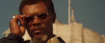 Movie still from “Deep Blue Sea” (1999), directed by Renny Harlin – A person wearing glasses and a white shirt; Close Up shot, Low angle