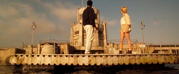 Movie still from “Deep Blue Sea” (1999), directed by Renny Harlin – A man and a woman are standing on a pier; Wide shot, Low angle