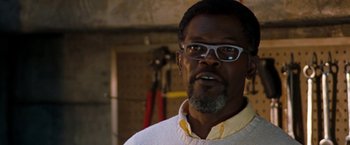 Movie still from “Deep Blue Sea” (1999), directed by Renny Harlin – A person wearing glasses and a white shirt; Close Up shot, Low angle