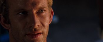 Movie still from “Deep Blue Sea” (1999), directed by Renny Harlin – A man's face with a dark background; Close Up shot, Over the shoulder angle