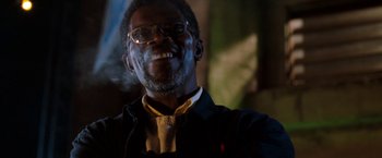 Movie still from “Deep Blue Sea” (1999), directed by Renny Harlin – A person wearing glasses and a tie; Close Up shot, Low angle