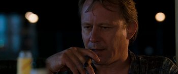 Movie still from “Deep Blue Sea” (1999), directed by Renny Harlin – A person smoking a cigarette; Close Up shot, Low angle