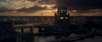 Movie still from “Deep Blue Sea” (1999), directed by Renny Harlin – A building that is next to a body of water at night; Extreme Wide shot, High angle
