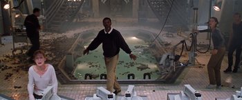 Movie still from “Deep Blue Sea” (1999), directed by Renny Harlin – A man standing in front of an abandoned swimming pool; Wide shot, High angle