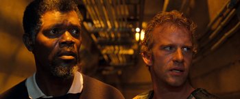 Movie still from “Deep Blue Sea” (1999), directed by Renny Harlin – Two men standing next to each other in a room; Close Up shot, Low angle