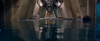 Movie still from “Deep Blue Sea” (1999), directed by Renny Harlin – A view of a body of water from underneath a bridge; Extreme Wide shot, Overhead angle