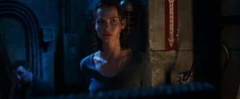Movie still from “Deep Blue Sea” (1999), directed by Renny Harlin – A woman with wet hair standing next to a wall; Close Up shot, Low angle