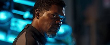 Movie still from “Deep Blue Sea” (1999), directed by Renny Harlin – A person with a beard looking into the distance; Close Up shot, Low angle