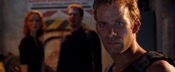 Movie still from “Deep Blue Sea” (1999), directed by Renny Harlin – A man standing next to another man in a dark room; Close Up shot, Low angle