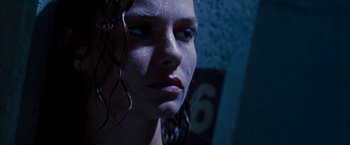 Movie still from “Deep Blue Sea” (1999), directed by Renny Harlin – A woman's face in the dark; Close Up shot, Low angle
