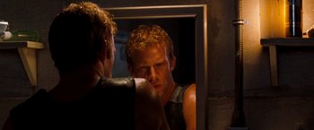 Movie still from “Deep Blue Sea” (1999), directed by Renny Harlin – A man looking at himself in the mirror; Close Up shot, Over the shoulder angle