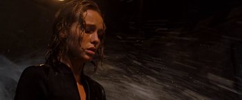 Movie still from “Deep Blue Sea” (1999), directed by Renny Harlin – A young woman with wet hair standing in front of a wall; Close Up shot, Low angle