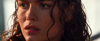 Movie still from “Deep Blue Sea” (1999), directed by Renny Harlin – A woman's face with long curly brown hair; Close Up shot, Over the shoulder angle