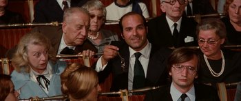 Movie still from “Deep Red” (1975), directed by Dario Argento – A group of people sitting in a room; Medium shot, High angle