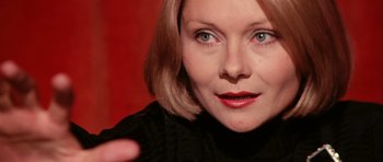 Movie still from “Deep Red” (1975), directed by Dario Argento – A woman's face in a black sweater; Close Up shot, Over the shoulder angle