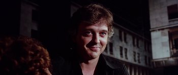 Movie still from “Deep Red” (1975), directed by Dario Argento – A person wearing a black shirt; Close Up shot, Low angle
