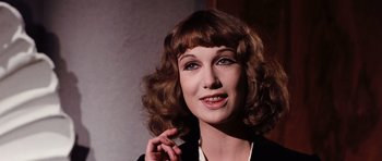 Movie still from “Deep Red” (1975), directed by Dario Argento – A person talking on a cell phone; Close Up shot, Low angle