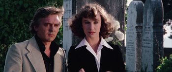 Movie still from “Deep Red” (1975), directed by Dario Argento – A man and a woman standing next to each other; Close Up shot, Low angle