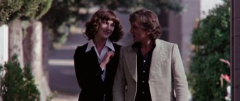 Movie still from “Deep Red” (1975), directed by Dario Argento – A man and a woman standing next to each other; Medium shot, Over the shoulder angle