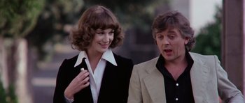 Movie still from “Deep Red” (1975), directed by Dario Argento – A man and a woman standing next to each other; Close Up shot, Low angle