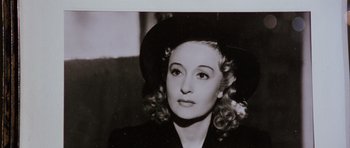 Movie still from “Deep Red” (1975), directed by Dario Argento – An old black and white photo of a woman wearing a hat; Close Up shot, High angle