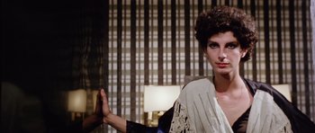 Movie still from “Deep Red” (1975), directed by Dario Argento – A woman standing in front of a window; Close Up shot, Over the shoulder angle