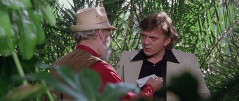 Movie still from “Deep Red” (1975), directed by Dario Argento – Two men are talking in a jungle setting; Close Up shot, Over the shoulder angle