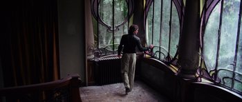 Movie still from “Deep Red” (1975), directed by Dario Argento – A man standing in front of an open window; Wide shot, Low angle