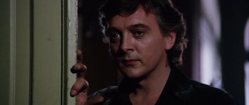 Movie still from “Deep Red” (1975), directed by Dario Argento – A person holding a hand on a wall; Close Up shot, Low angle