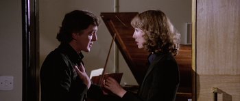 Movie still from “Deep Red” (1975), directed by Dario Argento – A man and a woman talking to each other; Close Up shot, Over the shoulder angle