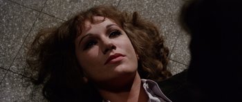 Movie still from “Deep Red” (1975), directed by Dario Argento – A person laying on the ground; Close Up shot, Overhead angle