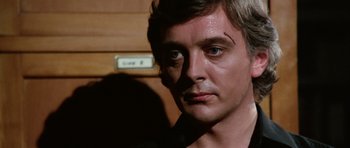 Movie still from “Deep Red” (1975), directed by Dario Argento – A person wearing a black shirt; Close Up shot, Low angle