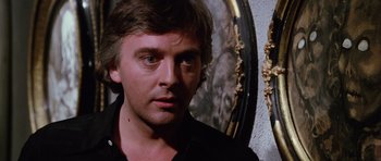 Movie still from “Deep Red” (1975), directed by Dario Argento – A person wearing a black shirt; Close Up shot, Low angle