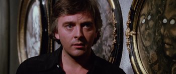 Movie still from “Deep Red” (1975), directed by Dario Argento – A person wearing a black shirt; Close Up shot, Low angle