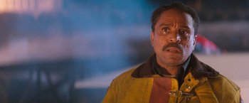 Movie still from “Demolition Man” (1993), directed by Marco Brambilla – A person wearing a yellow and brown jacket; Close Up shot, Low angle