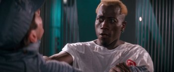 Movie still from “Demolition Man” (1993), directed by Marco Brambilla – A person wearing a white t - shirt; Close Up shot, Over the shoulder angle