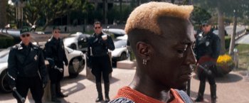Movie still from “Demolition Man” (1993), directed by Marco Brambilla – A police officer standing in front of a man with an afro haircut; Close Up shot, Over the shoulder angle