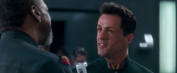Movie still from “Demolition Man” (1993), directed by Marco Brambilla – A person wearing a uniform; Close Up shot, Over the shoulder angle